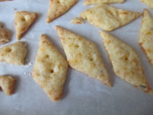 The blunt end of a wooden skewer makes a great hole.  The hole helps keep the cracker flat when baking.  I added two holes because of the diagonal shape.